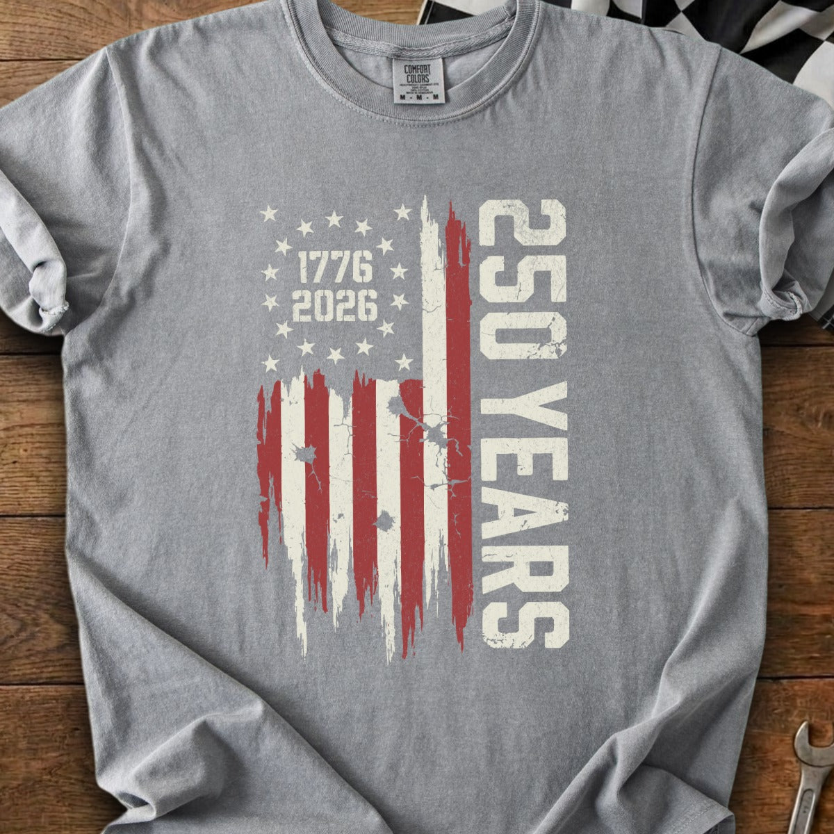 Gray t-shirt with distressed American flag graphic and "250 YEARS 1776 2026" text.