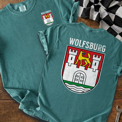 Teal t-shirt with Wolfsburg coat of arms and text on back.
