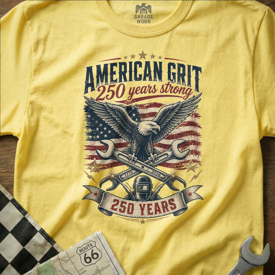 Yellow t-shirt with American Grit 250 years strong graphic featuring eagle and wrenches.