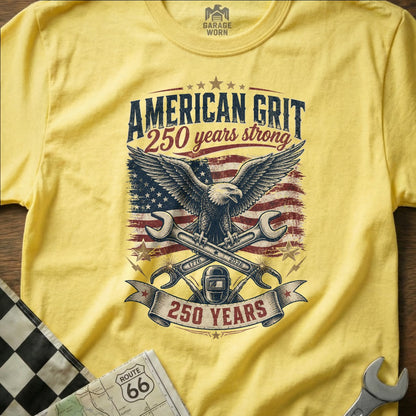 Yellow t-shirt with American Grit 250 years strong graphic featuring eagle and wrenches.