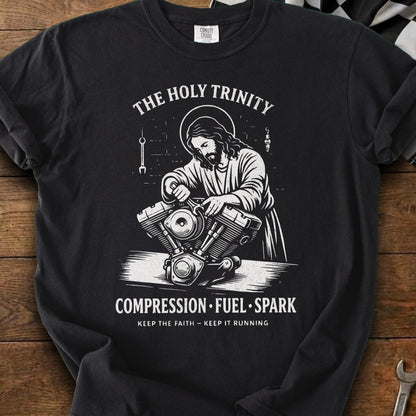 Jesus depicted working on a motorcycle engine with text "The Holy Trinity" and "Compression Fuel Spark".