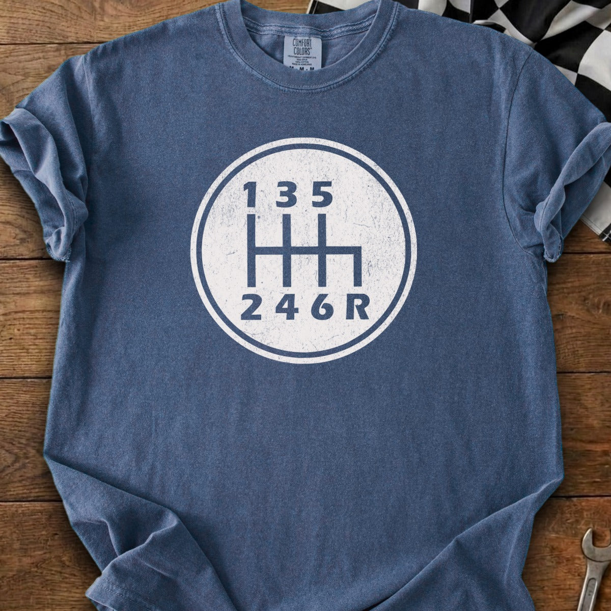 Blue shirt with white manual transmission shift pattern graphic and Comfort Colors tag.