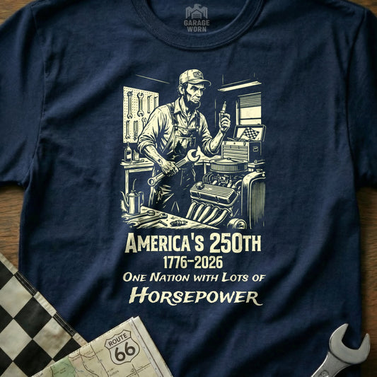 T-shirt graphic of mechanic working on engine, "America's 250th" and "Horsepower" text.