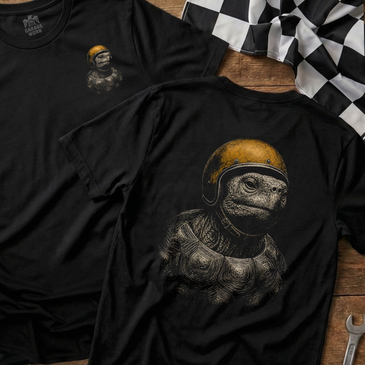 Black t-shirt with detailed print of a turtle wearing a yellow racing helmet.