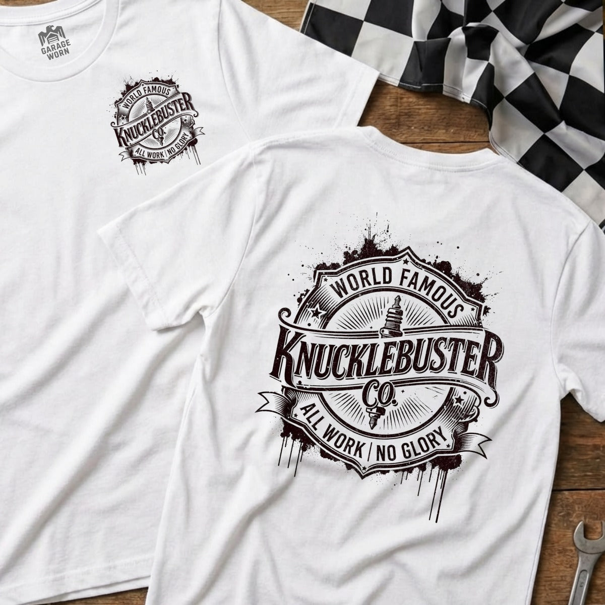 White t-shirt featuring "Knucklebuster Co." logo with "World Famous" and "All Work No Glory."