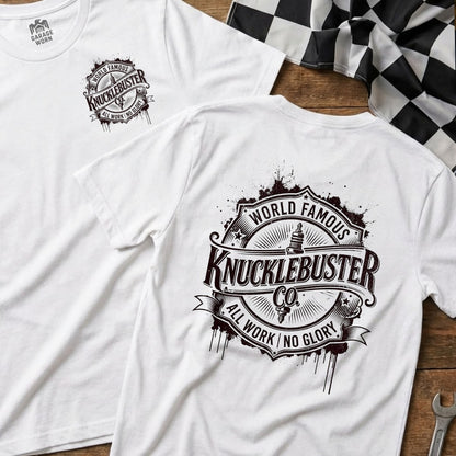 White t-shirt featuring "Knucklebuster Co." logo with "World Famous" and "All Work No Glory."