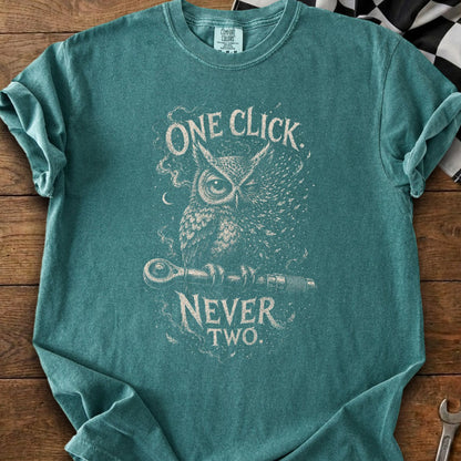 Teal t-shirt with an owl holding a wrench, text reads "ONE CLICK NEVER TWO."
