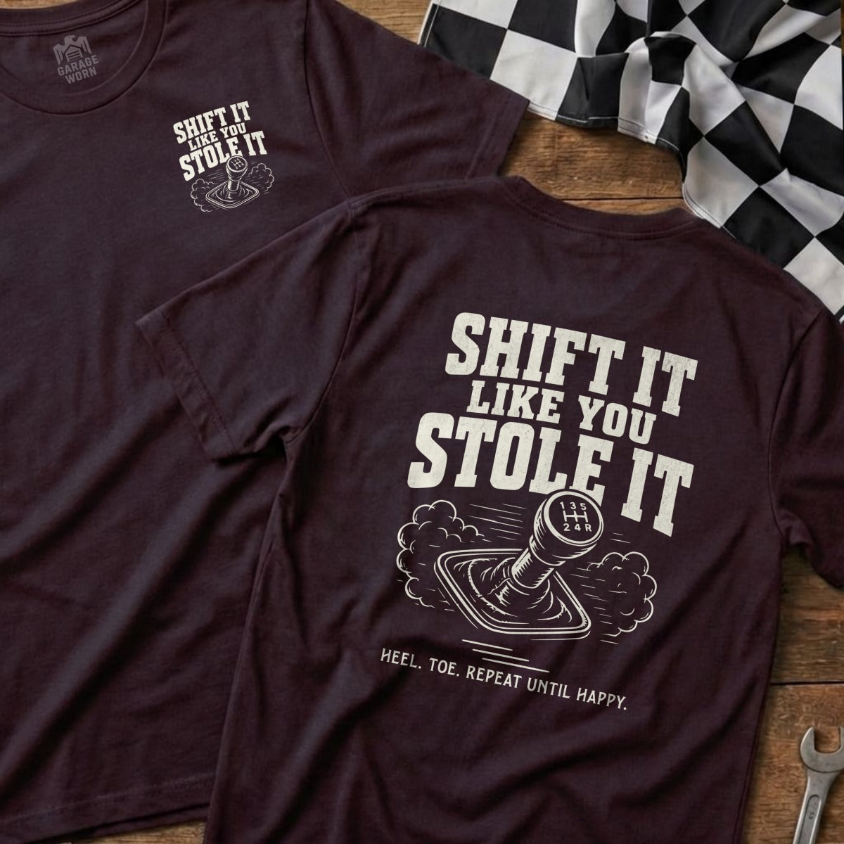 Burgundy t-shirt with "Shift It Like You Stole It" graphic and text.