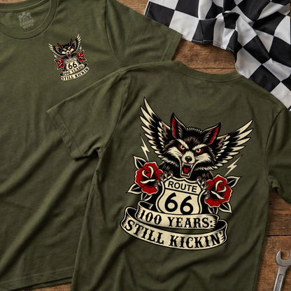Green t-shirt with Route 66 wolf and rose graphic, "100 Years: Still Kickin'" text.