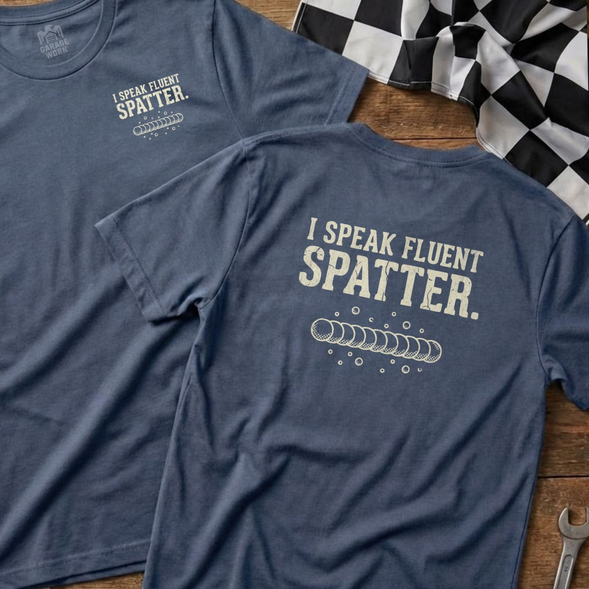 Blue t-shirt with "I Speak Fluent Spatter" text and concentric circles.