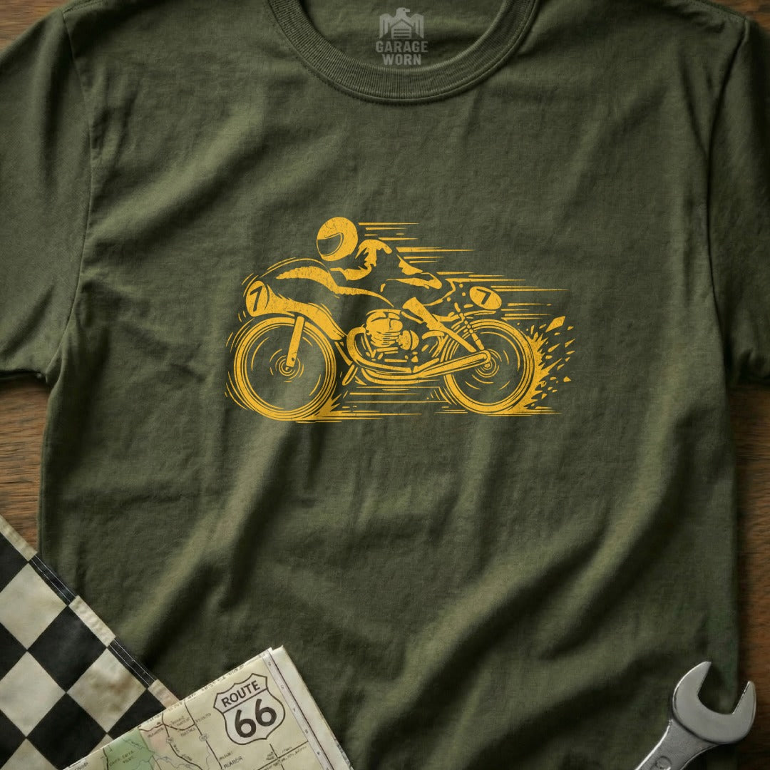Yellow motorcycle racer graphic on olive green t-shirt with checkered flag and map.