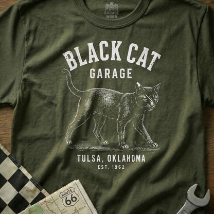 Olive green t-shirt with "Black Cat Garage Tulsa, Oklahoma Est. 1962" and a cat graphic.