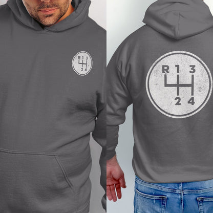 Charcoal hoodie with a white circle containing a grunge manual transmission gear shift diagram.