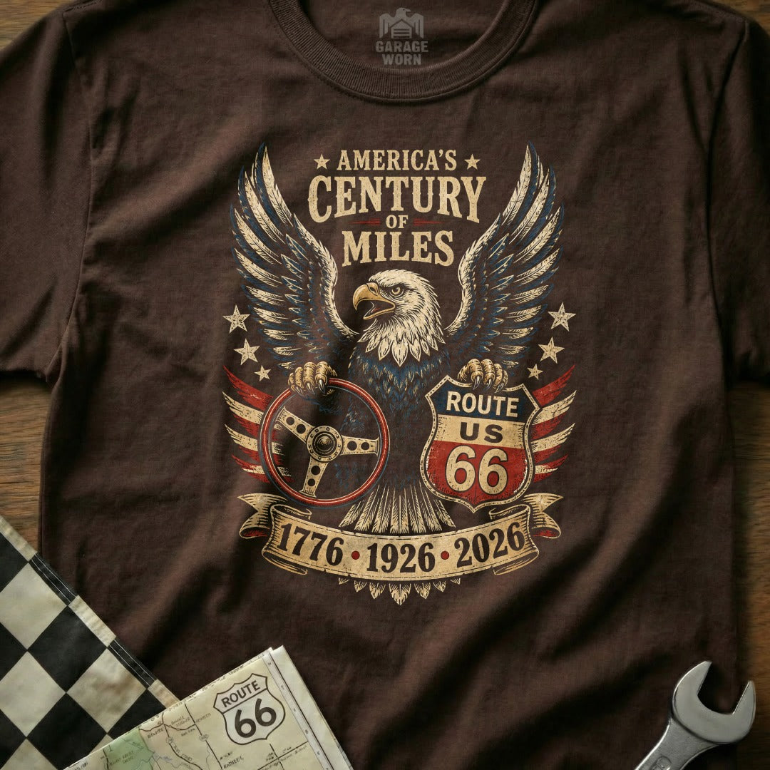 Brown t-shirt with eagle, Route 66 shield, steering wheel, and dates.