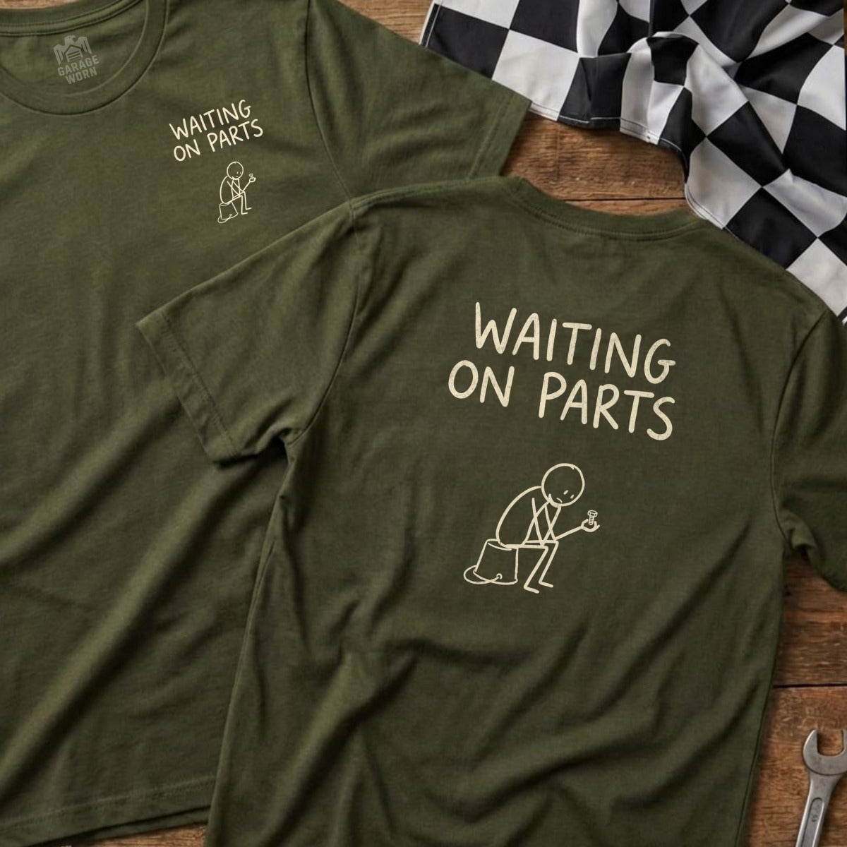 Two olive green t-shirts with "WAITING ON PARTS" and stick figure drawing.