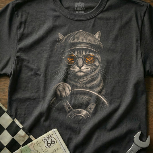 Cat wearing cap and goggles driving a car, with Route 66 map.