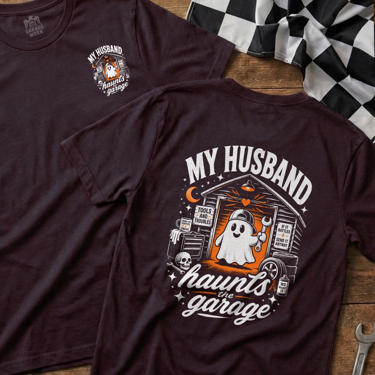 Dark t-shirt with "My Husband Haunts the Garage" graphic featuring a ghost in a garage.