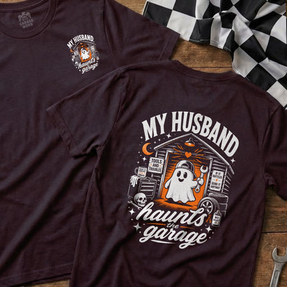 Dark t-shirt with "My Husband Haunts the Garage" graphic featuring a ghost in a garage.