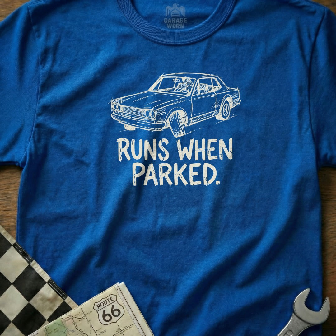 Blue t-shirt with white graphic of a vintage car and text "RUNS WHEN PARKED."