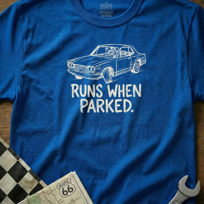 Blue t-shirt with white graphic of a vintage car and text "RUNS WHEN PARKED."