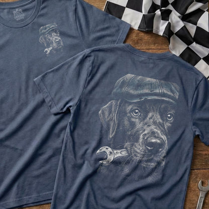 Black Labrador wearing a cap holding a wrench, printed on a navy t-shirt.