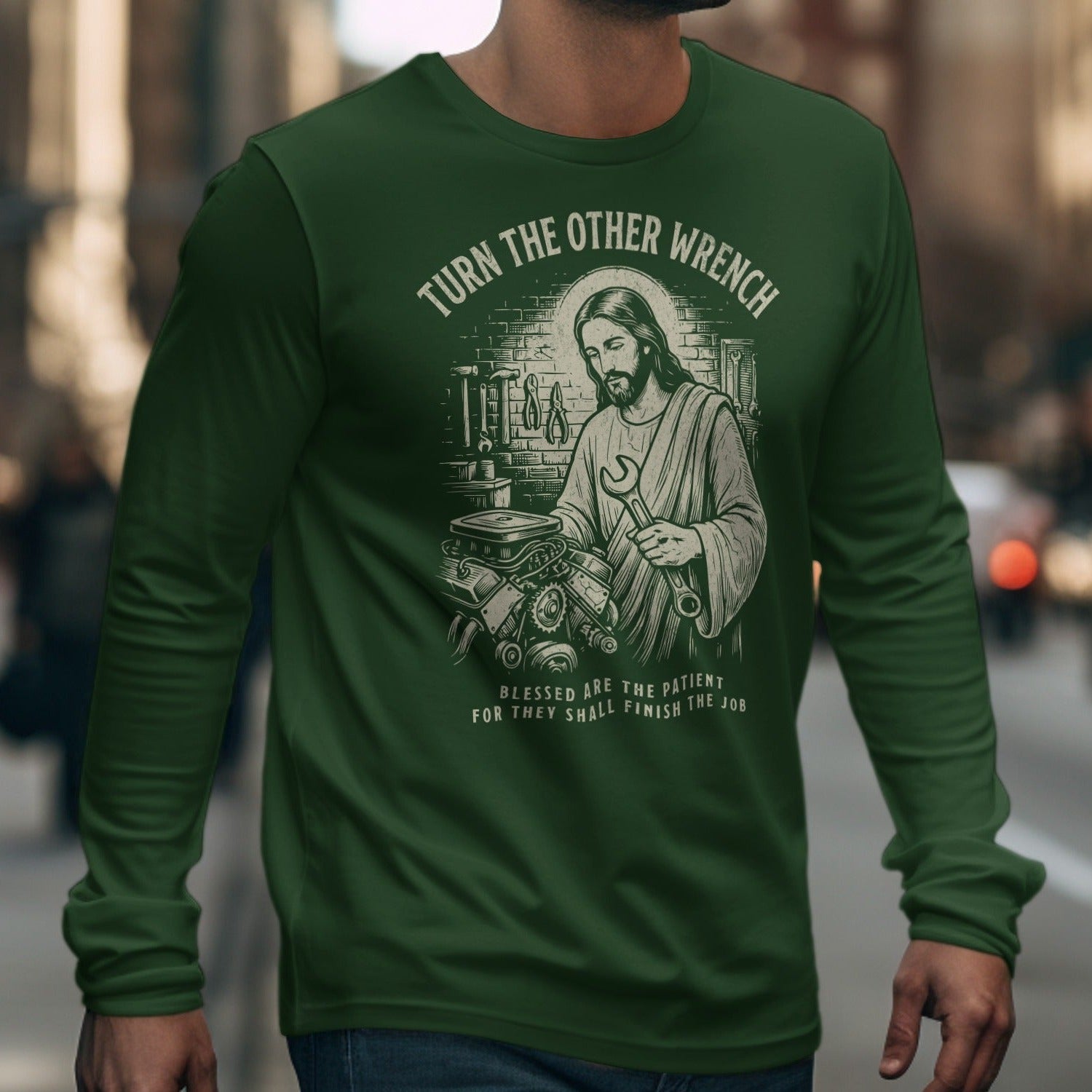 Green long-sleeve t-shirt with Jesus holding a wrench and text "Turn the Other Wrench".