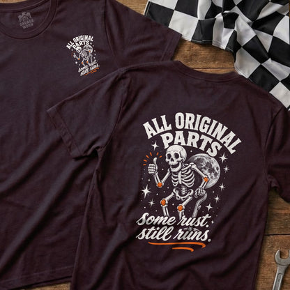 Dark t-shirt with skeleton graphic and text "All Original Parts. Some rust. Still runs."