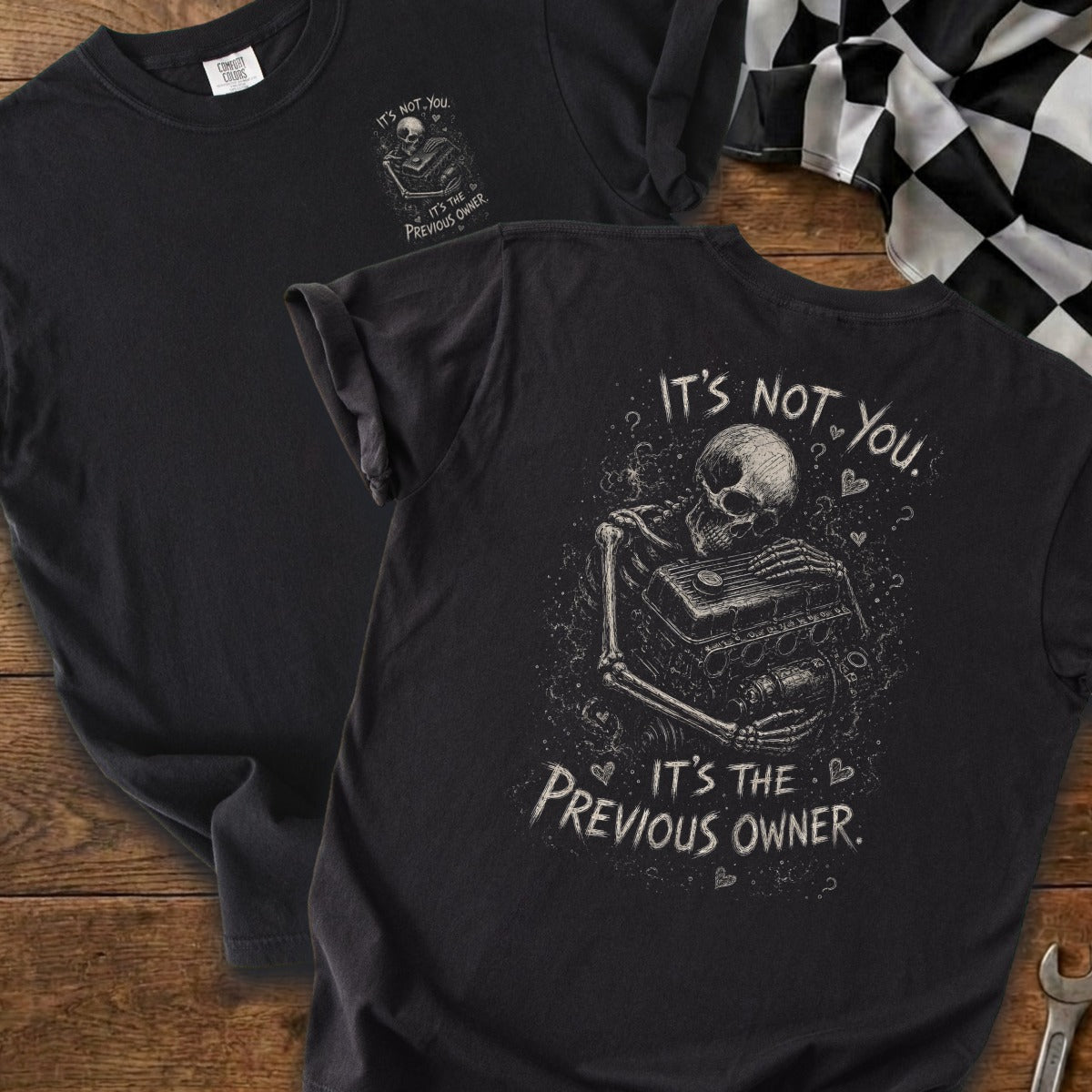 Black t-shirt with skeleton holding engine, "It's not you. It's the previous owner."