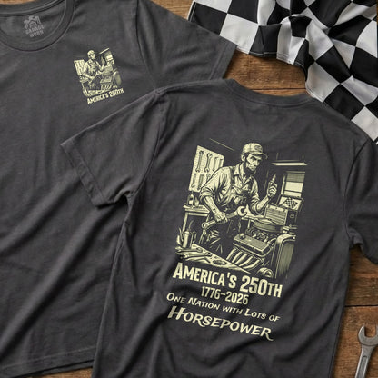 Dark grey t-shirt with illustration of a mechanic and text "America's 250th 1776-2026 One Nation with Lots of Horsepower".