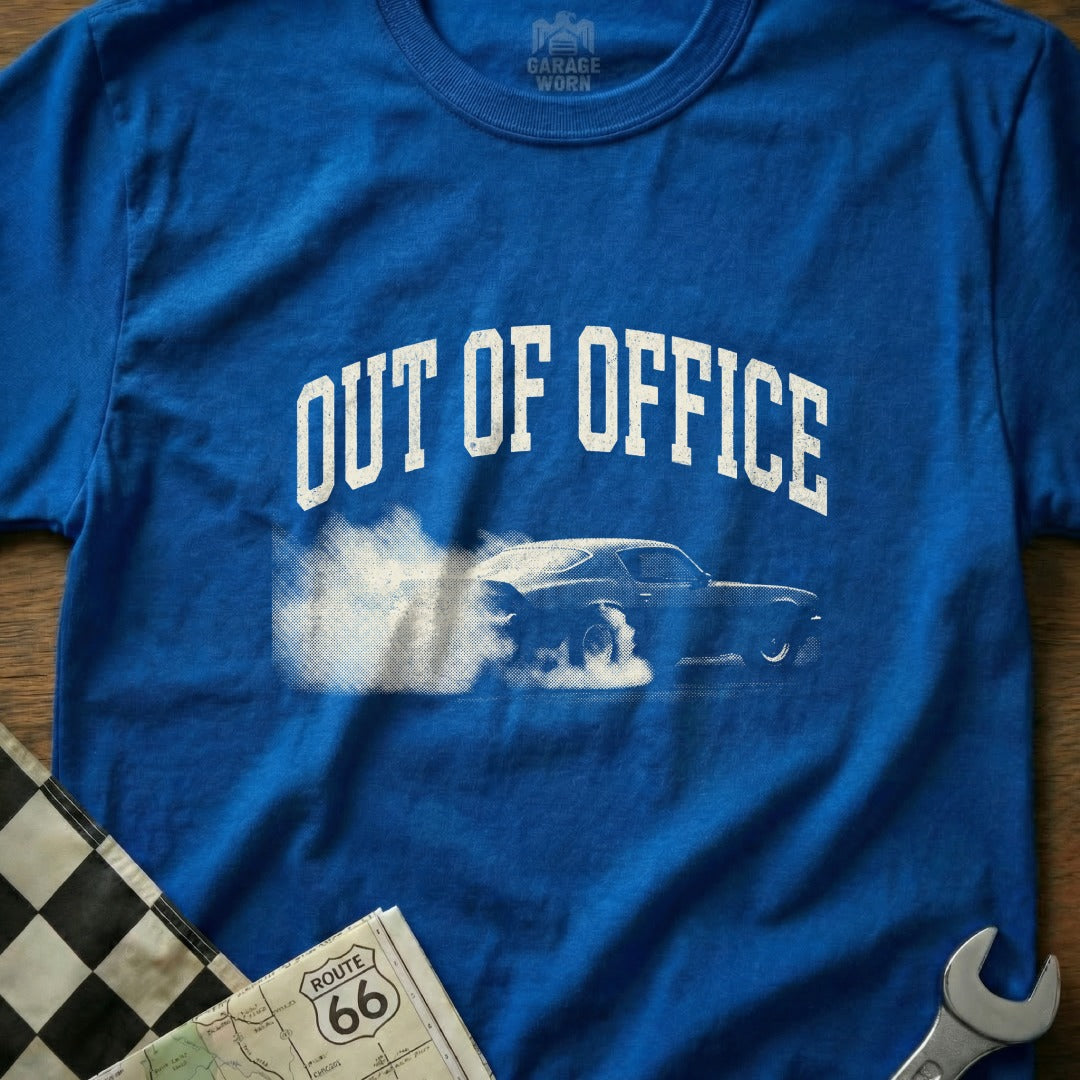 Blue t-shirt with "OUT OF OFFICE" and a car doing a burnout.