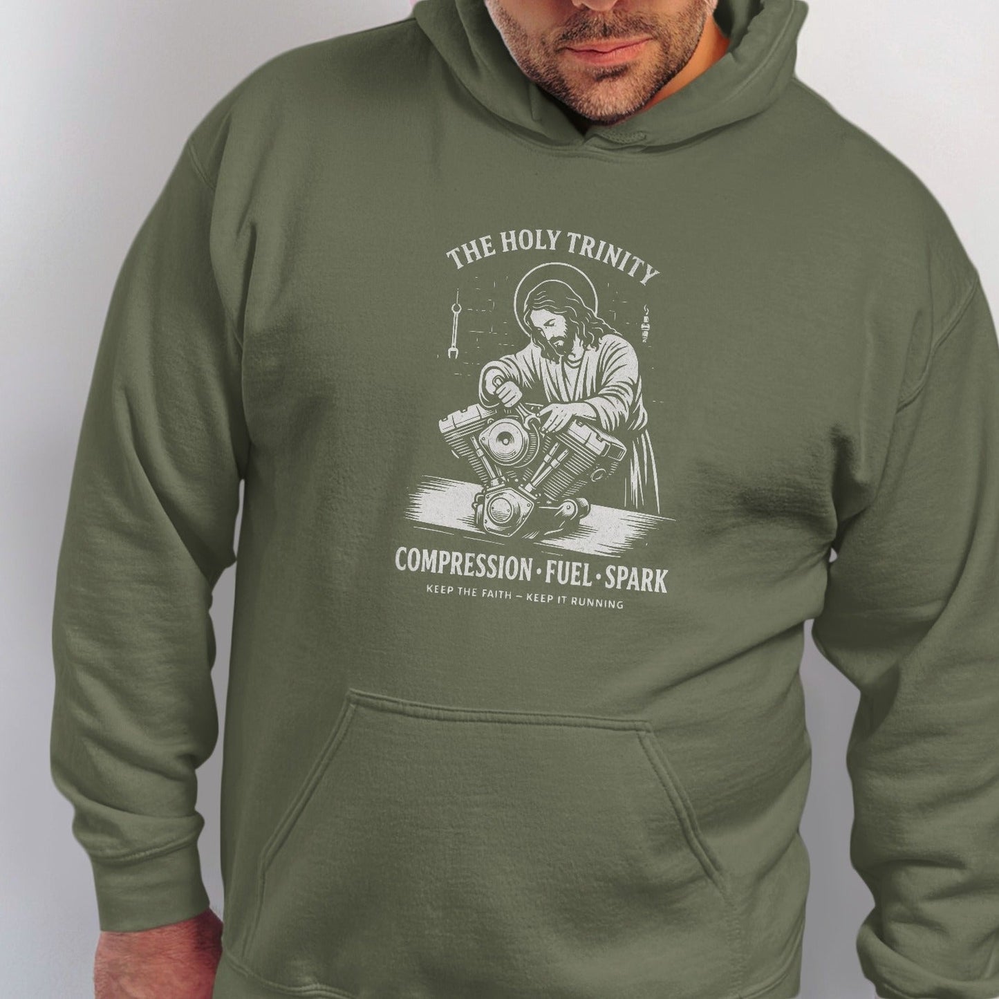 Green hoodie with "The Holy Trinity Compression Fuel Spark" graphic.