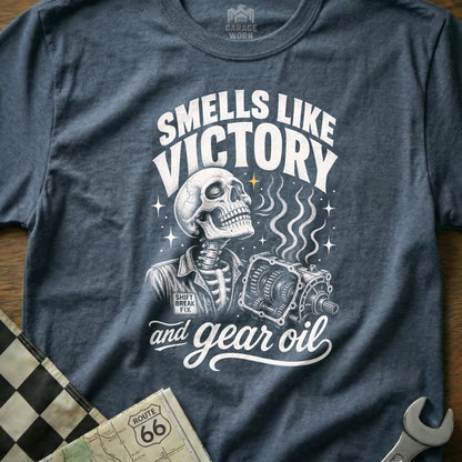 Skeleton holding gear shift, "Smells Like Victory and Gear Oil" text.