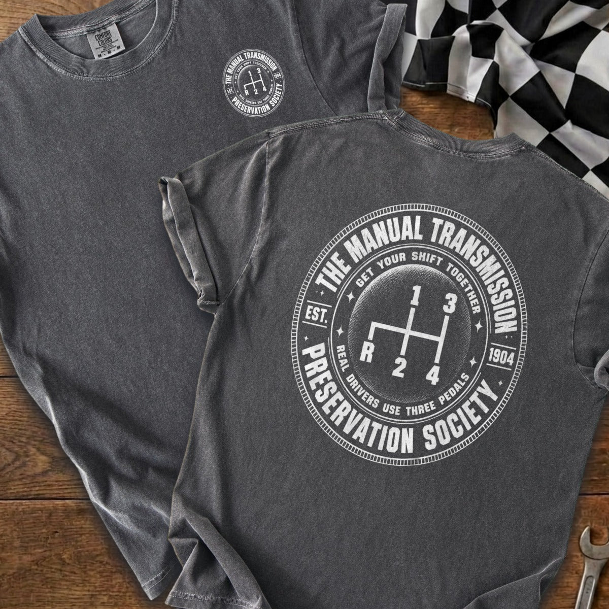 Dark gray t-shirt with white "Manual Transmission Preservation Society" graphic.
