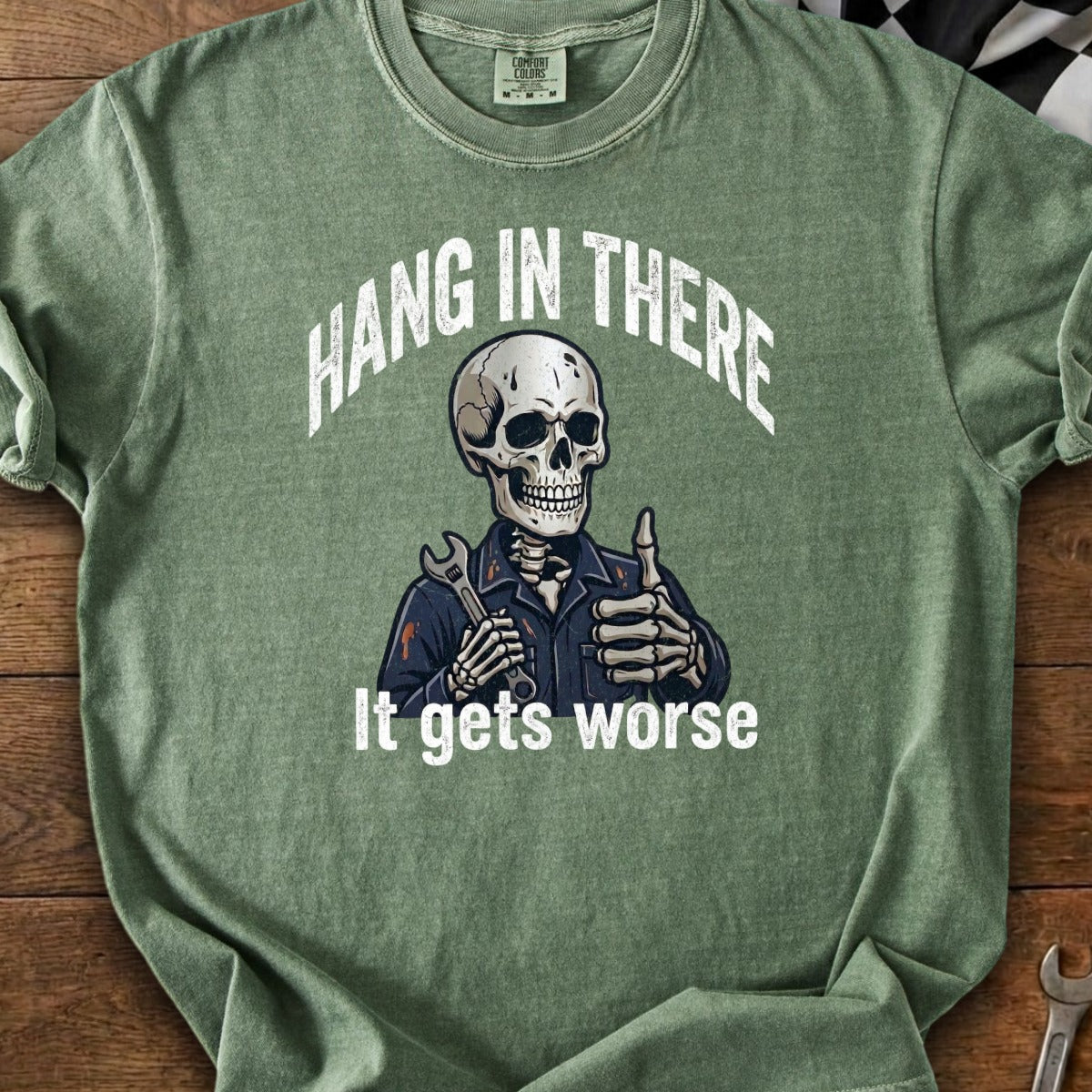 Skeleton mechanic holding wrench gives thumbs up with text "Hang in there. It gets worse."
