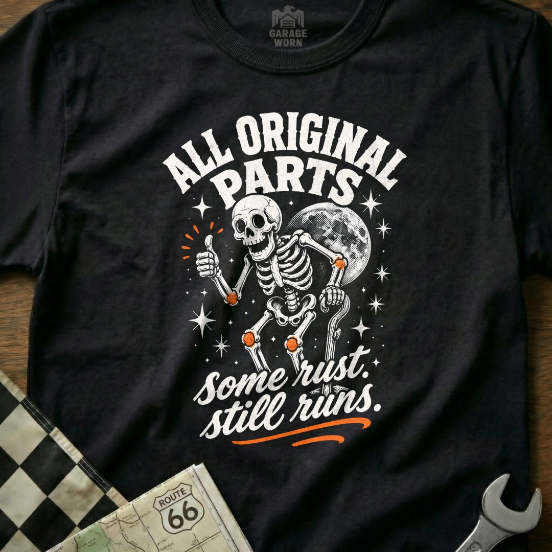 Black t-shirt with skeleton graphic and text "All Original Parts. Some Rust. Still Runs."