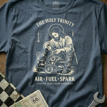 Jesus working on an engine with "The Holy Trinity" and "Air Fuel Spark" text.