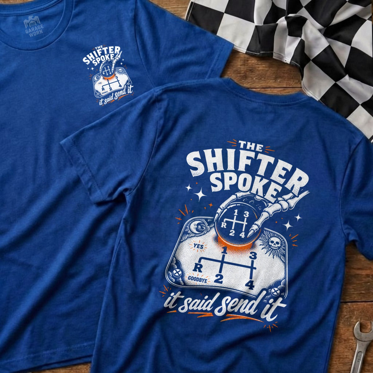 Blue t-shirt with skeleton hand on gear shift, "The Shifter Spoke, it said send it" text.