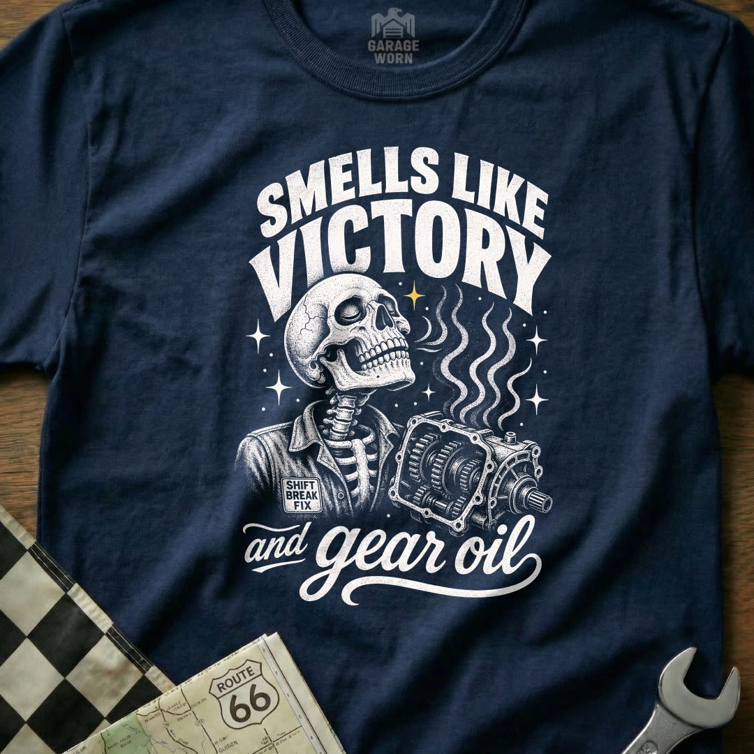 Skeleton wearing 'Shift Break Fix' shirt smells gear oil next to transmission.