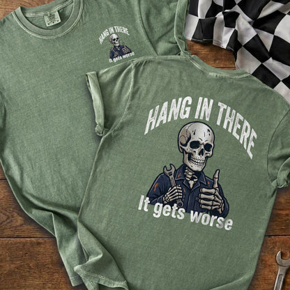 Green t-shirt with skeleton graphic and text "Hang In There It Gets Worse".