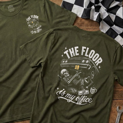 Green t-shirt with skeleton working on car graphic and text "The floor is my office".