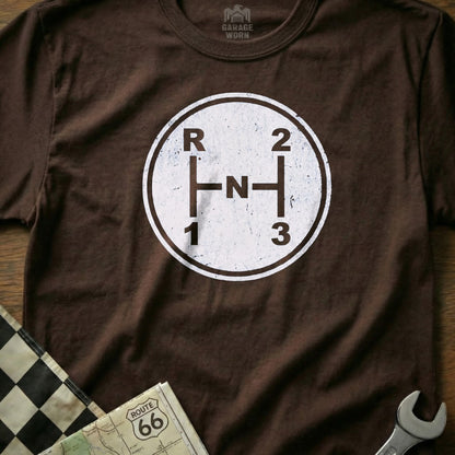 Brown t-shirt with white manual gear shift pattern: R, N, 1, 2, 3.