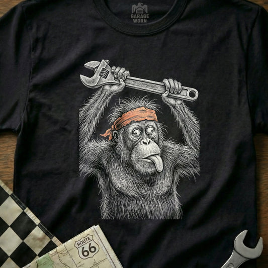 Orangutan wearing a headband, holding a wrench above its head, tongue out.