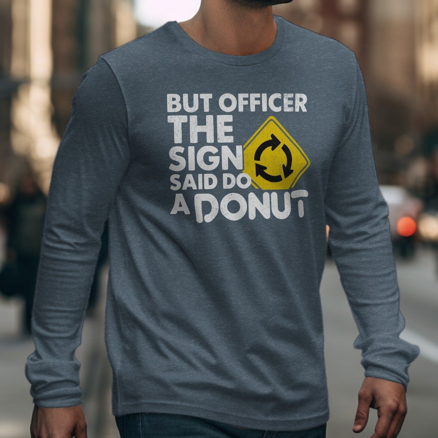 Long-sleeve t-shirt with "BUT OFFICER THE SIGN SAID DO A DONUT" text and roundabout symbol.