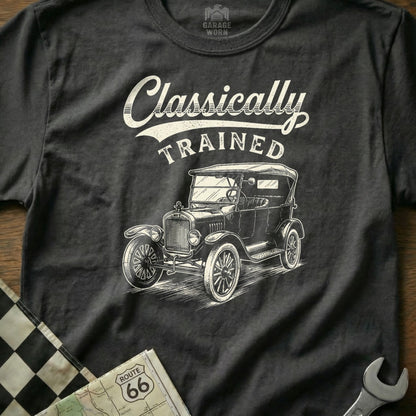 Dark t-shirt with graphic of a vintage car and text "Classically TRAINED".