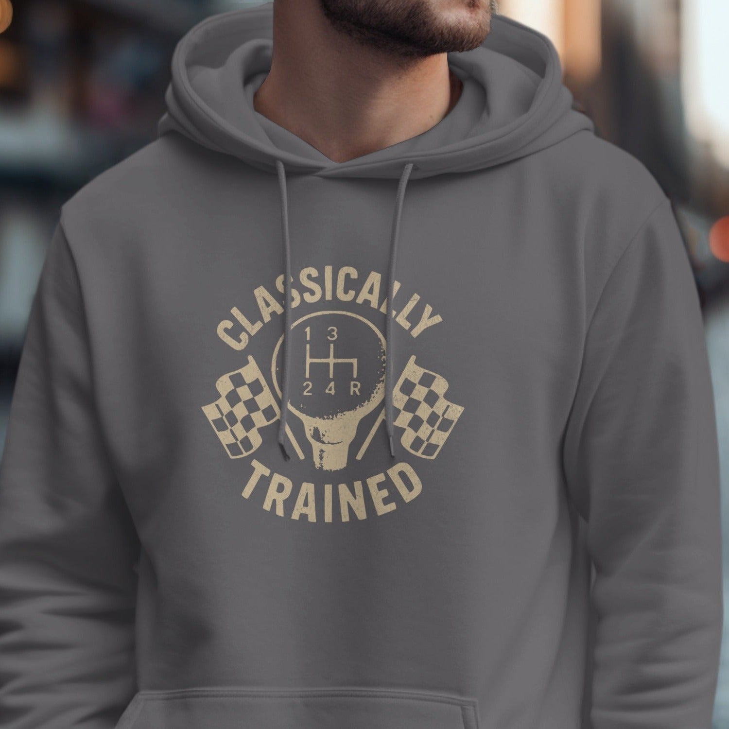 Grey hoodie with a beige graphic of a gear shift, checkered flags, and text.