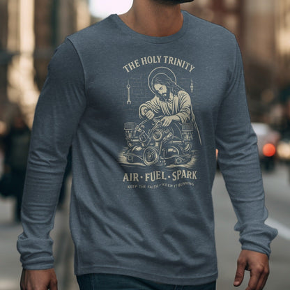 Long-sleeve shirt featuring Jesus working on an engine with text "The Holy Trinity Air Fuel Spark".