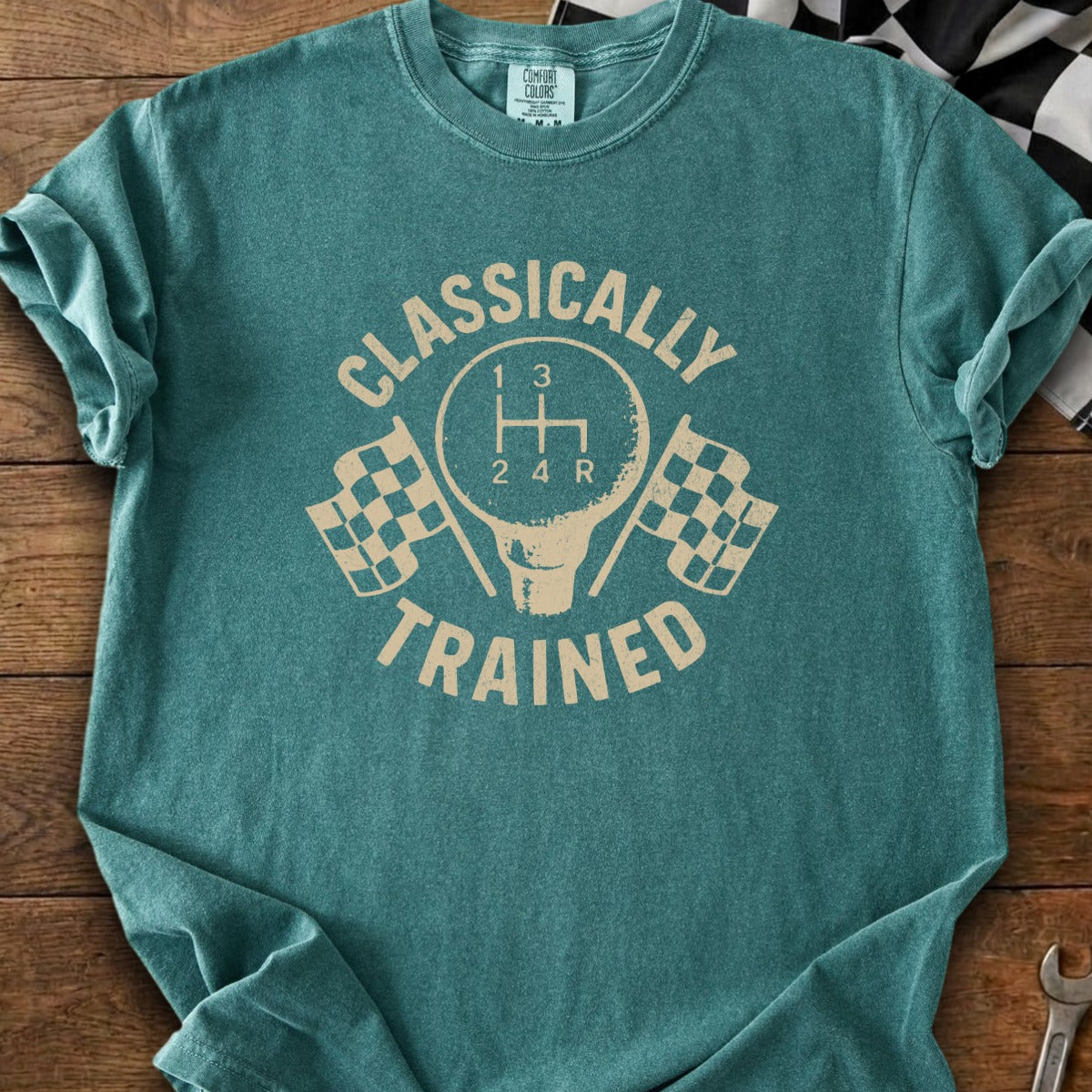 Teal t-shirt with "CLASSICALLY TRAINED" text, gear shift, and checkered flags.