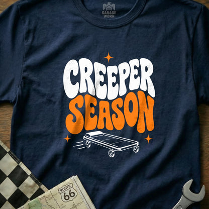 Navy t-shirt with "Creeper Season" text and a mechanic's creeper illustration.