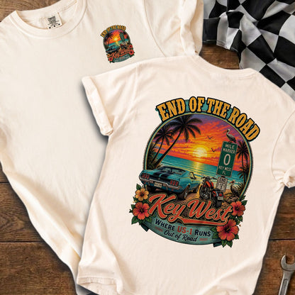 Key West "End of the Road" graphic with car, motorcycle, and sunset.