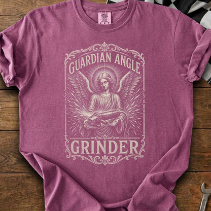 Pewter graphic on a deep mauve t-shirt with the words "Guardian Angle Grinder."